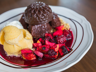 Chocolate cake with fruit peach, black currant, blueberry, apple