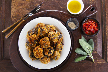 fried eggplant appetizer. vegetarian aubergine balls. with tomat