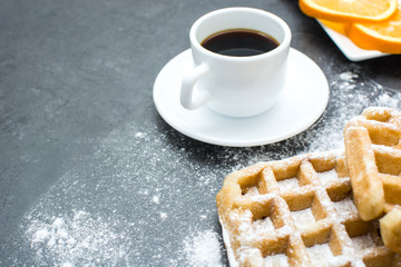 Waffles,oranges and coffee on the kitchen table