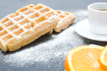 Waffles,oranges and coffee on the kitchen table
