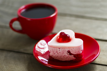 cream cake in the form of hearts and black coffee