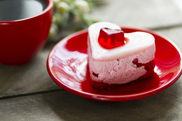 cream cake in the form of hearts and black coffee