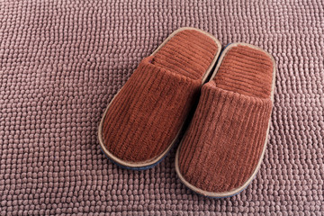 Brown wool slipper on mat