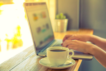 Coffee cup  with laptop on old wooden table ( Filtered image pro