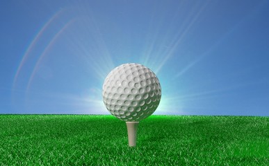 Golf ball on tee on green turf, with blue sky in background
