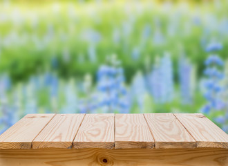 Wood table with blur blue flower background