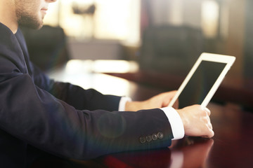 Businessman working with tablet in office, closeup