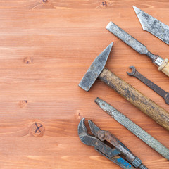 old rusty construction instruments on the wooden background