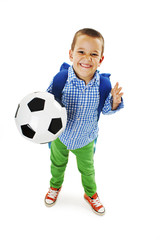Happy young school boy holding a football. Isolated on white background 