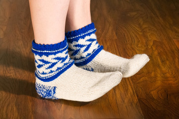 Feet warm beautiful socks on a wooden floor