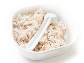 brown rice with spoon plastic in the box isolated white background