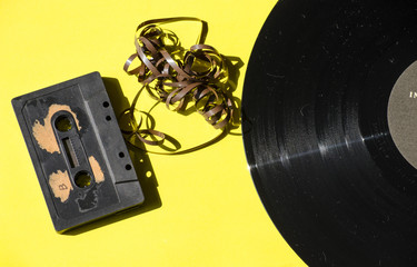 cassette and vinyl record on a colored background yellow retro
