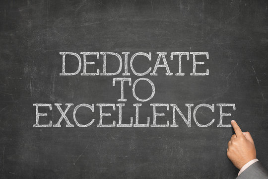Dedicate to excellence text on blackboard