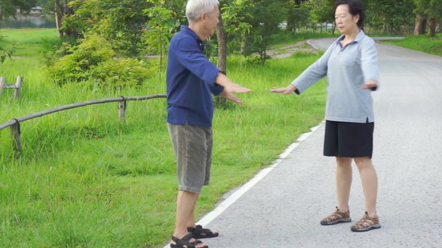 Video of  happy Asian senior couple walking exercise along the lake. Abstract love health and nature
