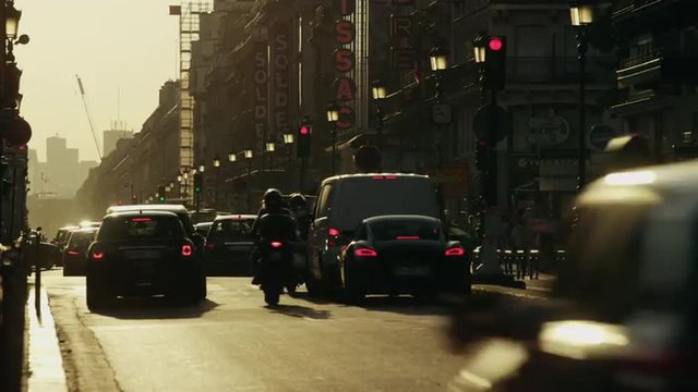 Wide time lapse shot of traffic on busy city street / Paris, France