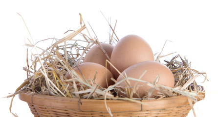 Egg,basket,straw on white background.