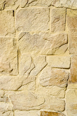 Yellow stone cladding plates on the wall