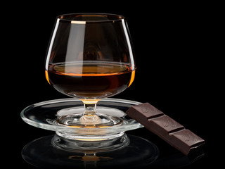 Cognac and chocolate it is isolated on black