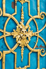Blue door decorated with golden adornment