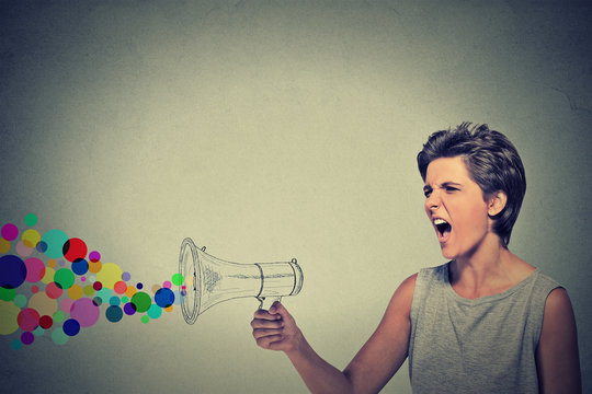 angry screaming young woman holding megaphone