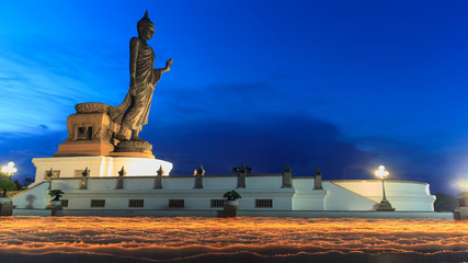 Fototapeta premium many people have moving candle light around big buddha in Visakha Bucha day