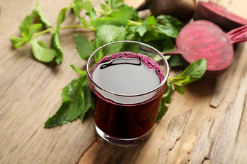 Fresh beet juice on wooden table, closeup