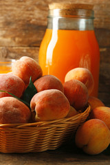 Ripe peaches and juice on wooden background