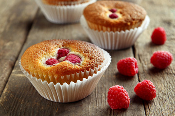 Delicious cupcake with berries on wooden table close up