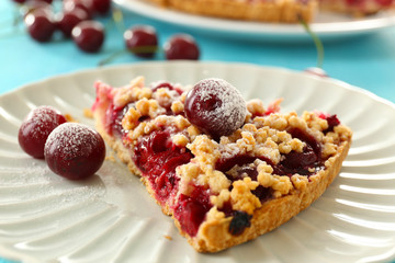 Tasty homemade pie with cherries on table close up