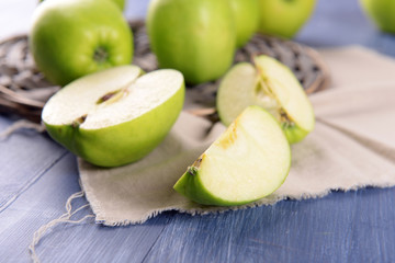Sliced green apple on wooden table, closeup