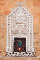 Religious icon of Madonna on a house facade in Mdina, Malta.