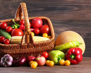 Heap of fresh fruits and vegetables on wooden background