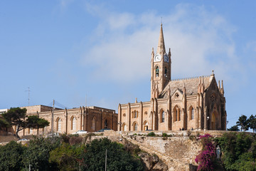 Fototapeta na wymiar Mgarr harbor with view on church to Our Lady of Lourdes. Gozo, Malta.