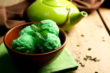 Homemade green tea ice-cream on wooden background