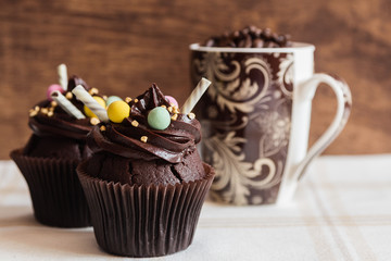 Chocolate cupcakes on rustic wooden background
