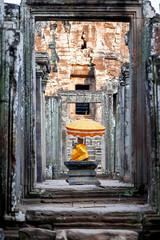 Sanctuary with Buddha statue and sacral decorations in Angkor Wat, Cambodia.