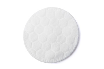One round cotton cosmetic pad on white © Oliver Wilde