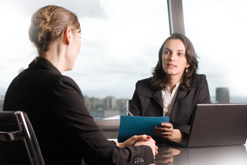 Serious job interview of a woman with a business recruiter