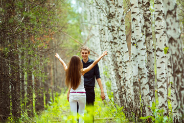 Young couples dating at summer birch forest background.