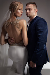 Beautiful wedding couple posing in studio.