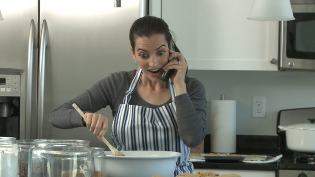 woman baking and talking on the phone