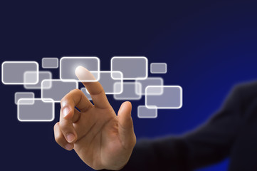 businessman hand pushing on a touch screen interface on blue bac