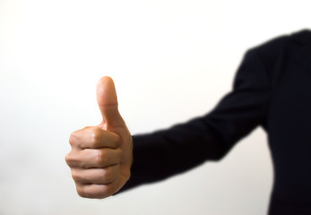 human hand showing thumbs up on the foreground