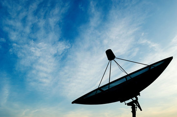 Satellite dish transmission data on blue sky background