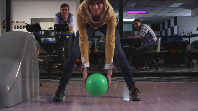 young woman and friends at a bowling alley