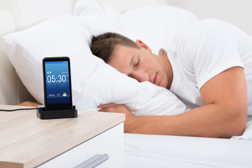 Man Sleeping With Alarm On Mobile Phone