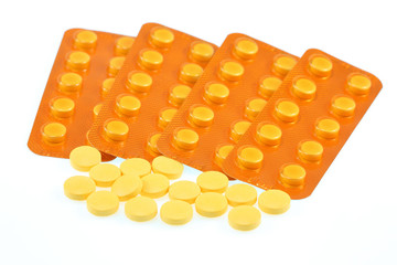 yellow pills on white background