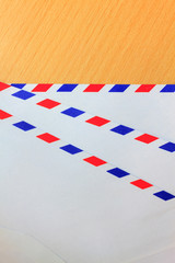 Envelope on wood background.