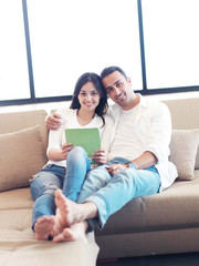 couple at modern home using tablet computer