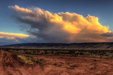AZ-UT-Vermillion Cliffs Wilderness-S Coyote Buttes.Sunset and thunderheads viewed from remote House Rock Valley Road.